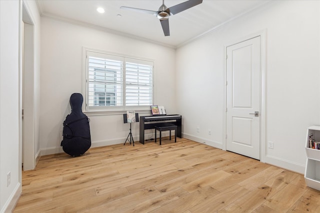 miscellaneous room with baseboards, wood finished floors, ceiling fan, and ornamental molding