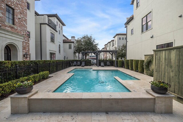 pool featuring a fenced backyard, a pergola, a residential view, and a patio