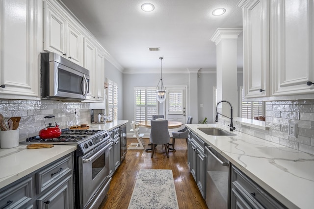 kitchen featuring white cabinets, a sink, visible vents, stainless steel appliances, and gray cabinetry