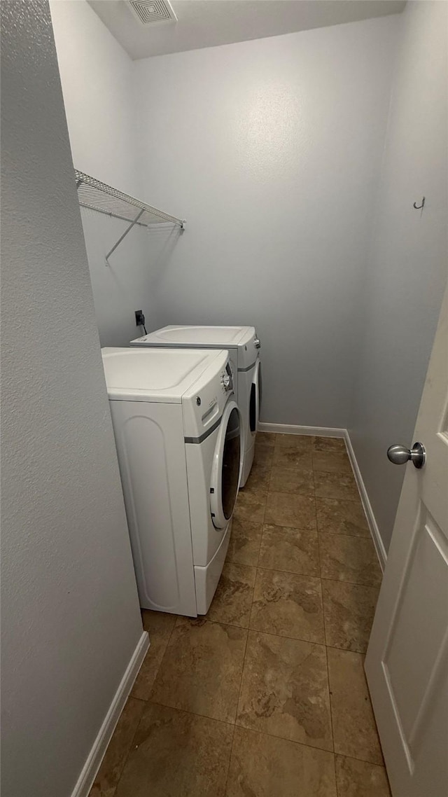 laundry area with baseboards, visible vents, laundry area, and independent washer and dryer