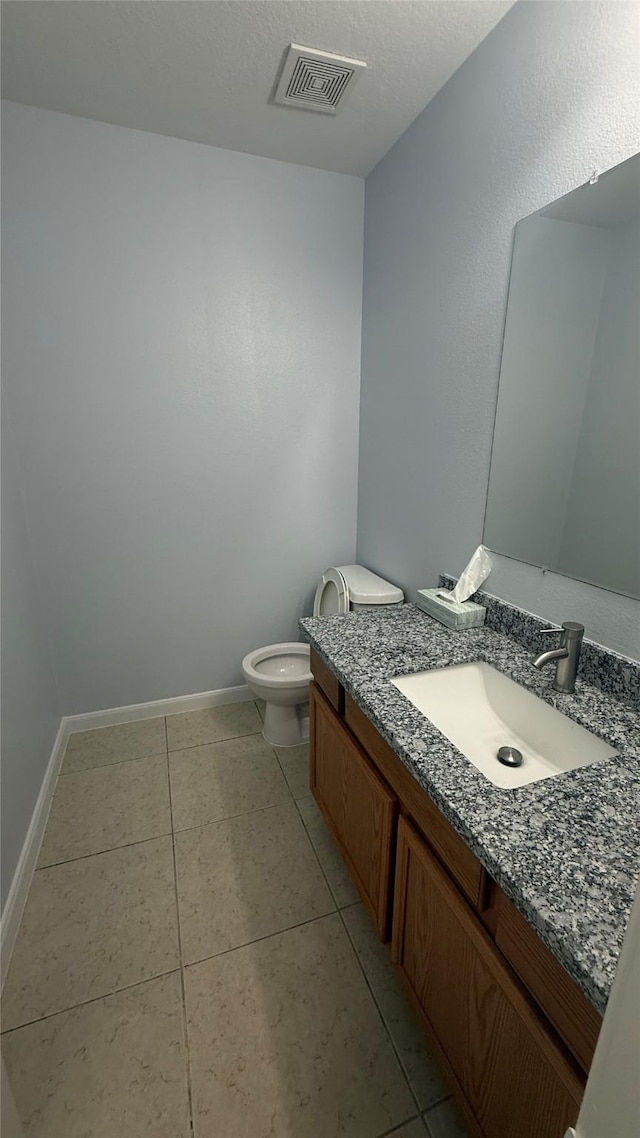 bathroom with baseboards, visible vents, toilet, and vanity