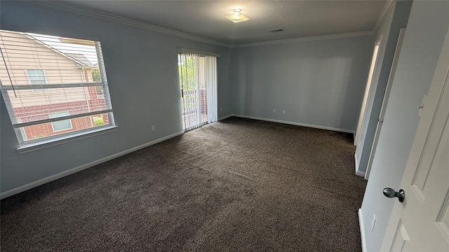 empty room featuring baseboards, crown molding, dark colored carpet, and visible vents