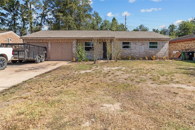 single story home with a garage, a front lawn, brick siding, and concrete driveway