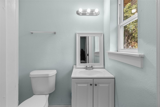 bathroom featuring toilet and vanity