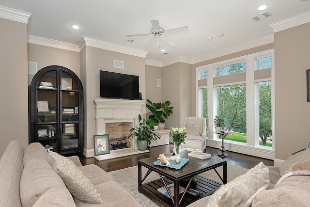 75 Colonial Row Dr, The Woodlands, TX 77380 - living area featuring a ceiling fan, wood finished floors, a fireplace with raised hearth, and recessed lighting