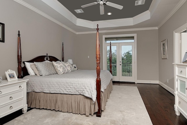 75 Colonial Row Dr, The Woodlands, TX 77380 - bedroom with crown molding, wood finished floors, french doors, a tray ceiling, and visible vents