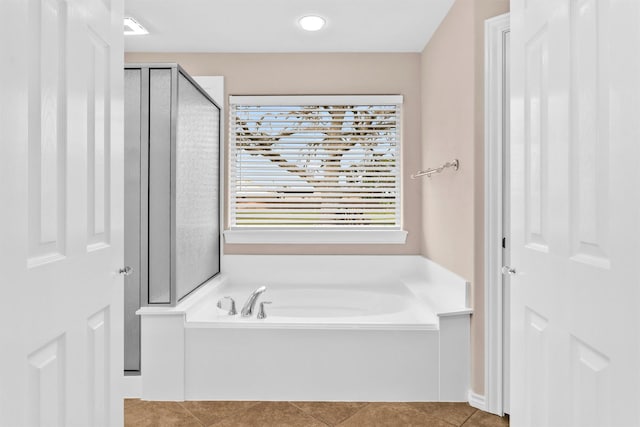 full bath featuring a bath, a shower stall, and tile patterned floors