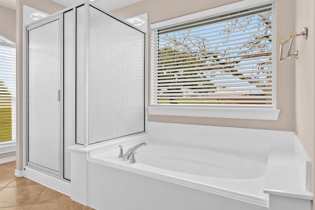 bathroom featuring a stall shower, tile patterned flooring, and plenty of natural light