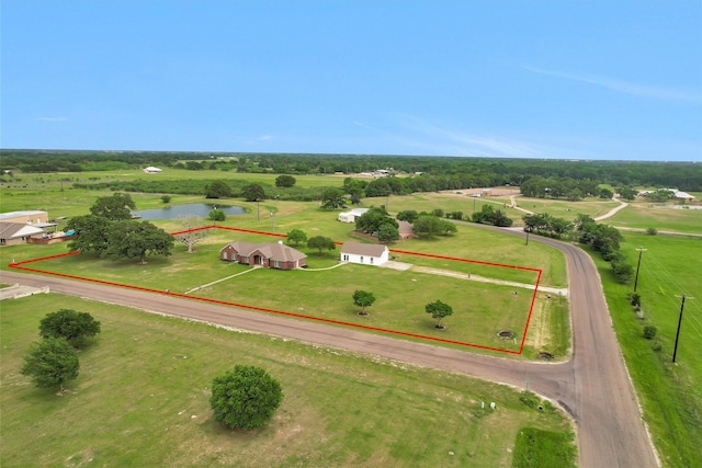 birds eye view of property with a rural view and a water view