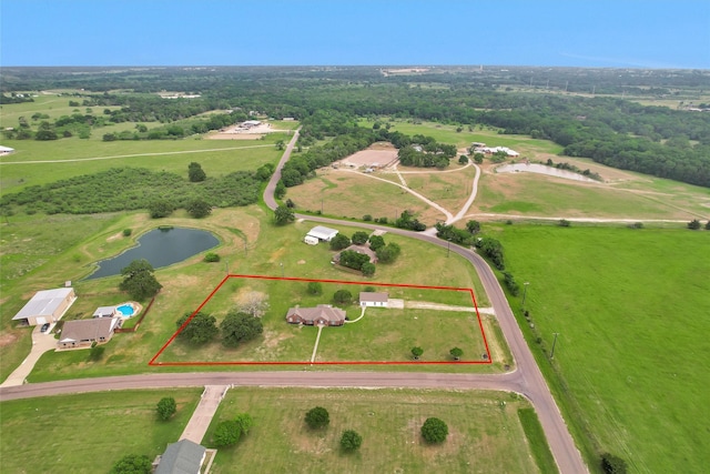 drone / aerial view featuring a rural view and a water view