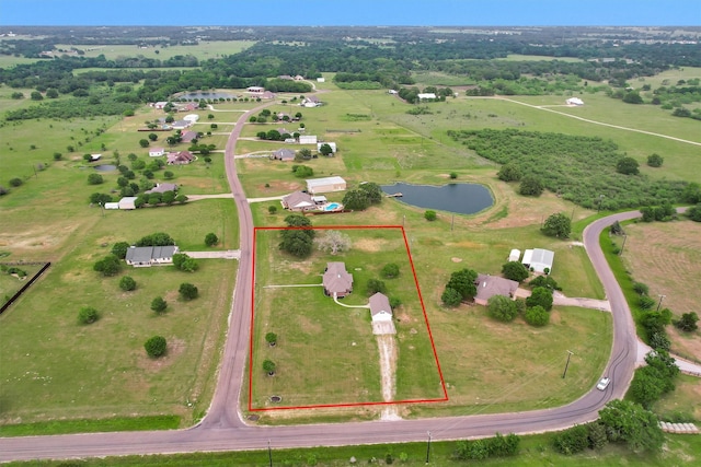 aerial view with a rural view and a water view