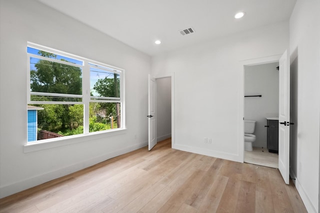 6703 Del Rio St, Houston, TX 77021 - unfurnished bedroom with light wood-type flooring, recessed lighting, and connected bathroom
