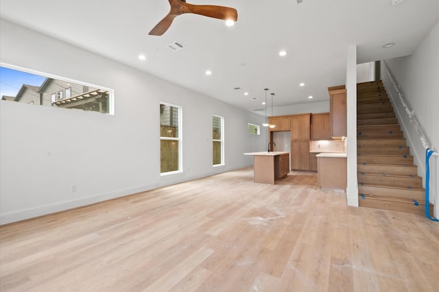 6703 Del Rio St, Houston, TX 77021 - unfurnished living room featuring light wood-style flooring, stairs, recessed lighting, and a ceiling fan