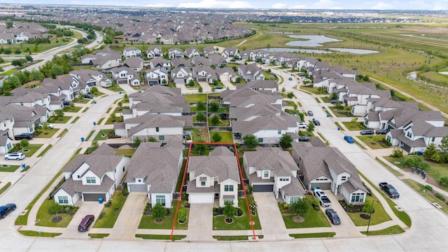 birds eye view of property with a residential view and a water view