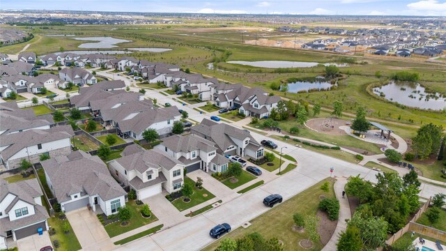 drone / aerial view featuring a residential view and a water view