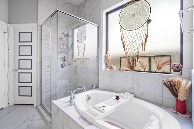 full bath featuring a garden tub, a marble finish shower, and marble finish floor