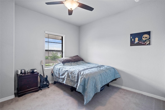 carpeted bedroom with baseboards and ceiling fan