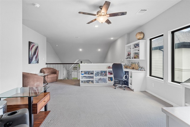 office area with vaulted ceiling, a ceiling fan, visible vents, and carpet
