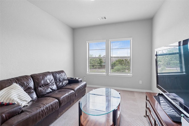 carpeted living room with visible vents and baseboards