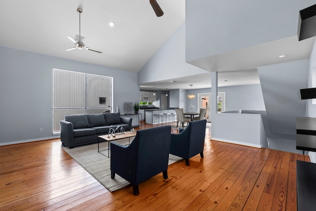 1522 Drew St, Houston, TX 77004 - living area featuring a ceiling fan, high vaulted ceiling, light wood-style floors, and baseboards