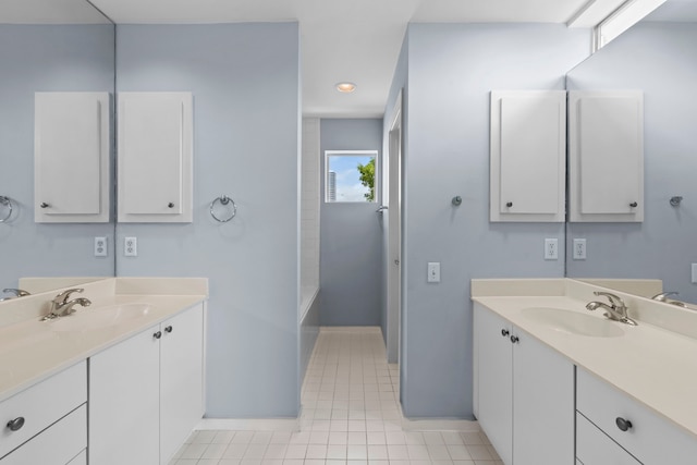 1522 Drew St, Houston, TX 77004 - bathroom with two vanities, baseboards, tile patterned floors, and recessed lighting