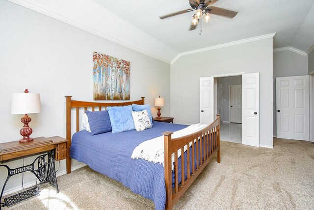 bedroom featuring a ceiling fan, carpet floors, baseboards, lofted ceiling, and ornamental molding