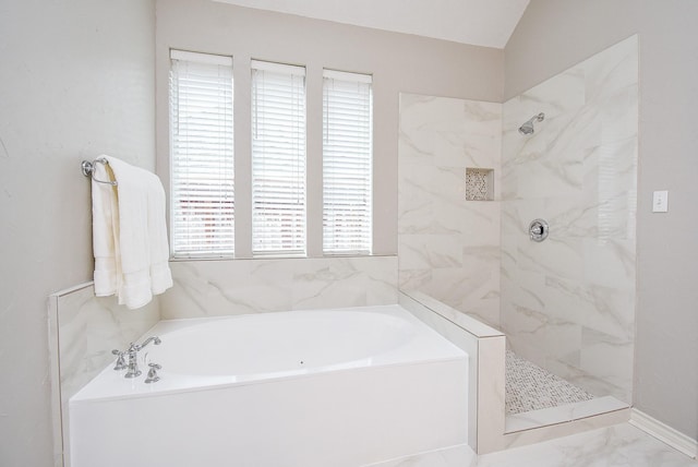 full bath featuring a garden tub, marble finish floor, and a tile shower
