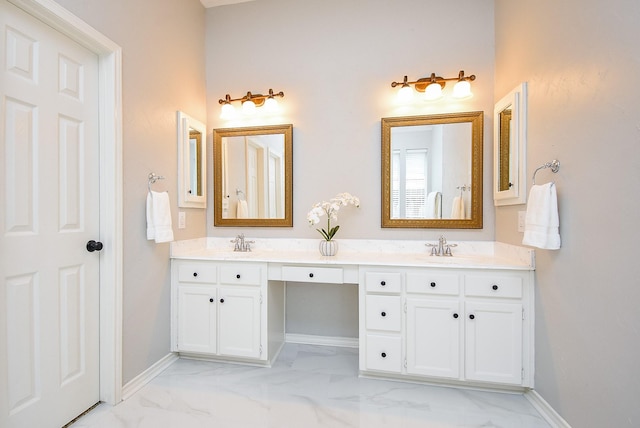 bathroom with double vanity, marble finish floor, baseboards, and a sink