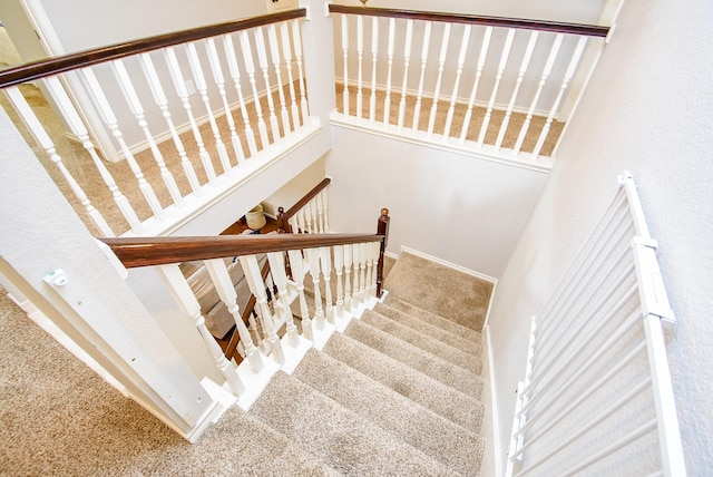 stairs featuring a towering ceiling and carpet