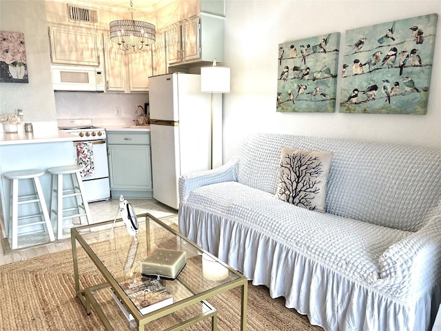 interior space featuring a sink, a chandelier, white appliances, light countertops, and visible vents