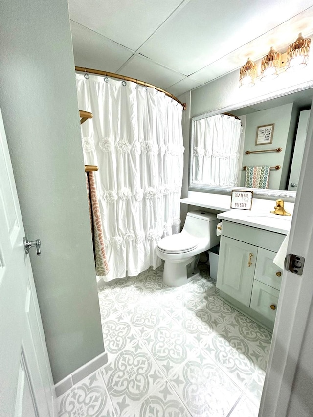 bathroom with toilet, vanity, tile patterned floors, and curtained shower