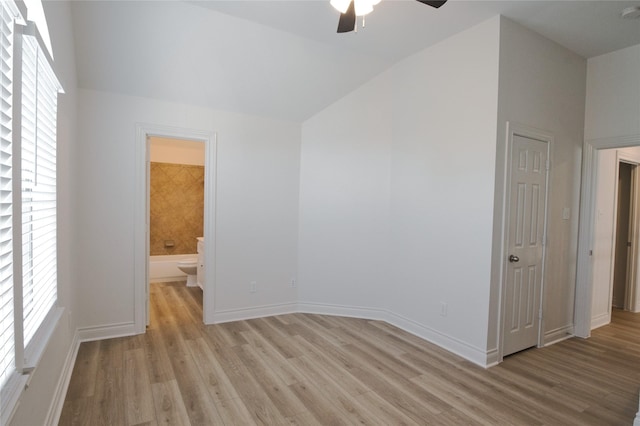 bonus room featuring lofted ceiling, a wealth of natural light, light wood-type flooring, and a ceiling fan