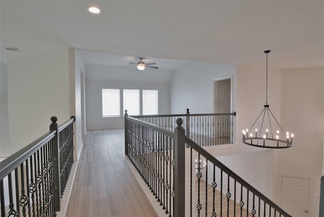 hall with recessed lighting, an inviting chandelier, an upstairs landing, visible vents, and light wood-style flooring