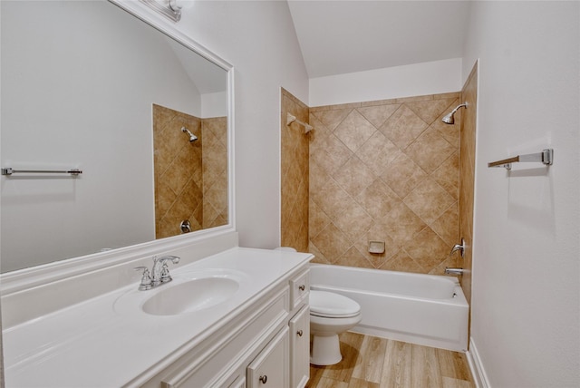 full bathroom with wood finished floors, vaulted ceiling, toilet, vanity, and tub / shower combination