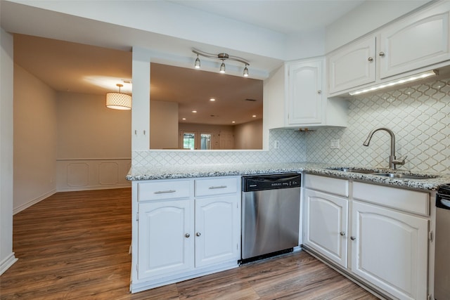 kitchen with dishwasher, white cabinets, backsplash, and a sink