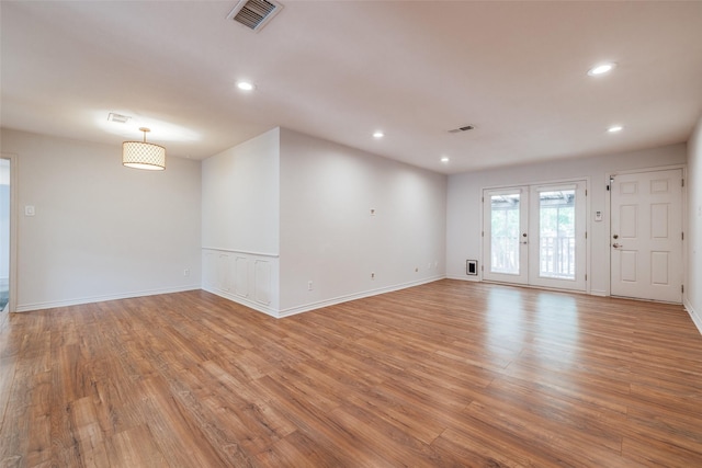 spare room with recessed lighting, light wood-style flooring, and visible vents