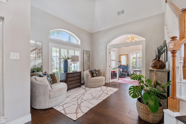 interior space featuring stairway, visible vents, a chandelier, wood finished floors, and high vaulted ceiling