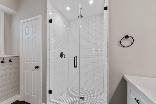 bathroom with a shower stall and recessed lighting