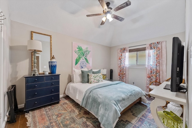 bedroom with baseboards, ceiling fan, and vaulted ceiling