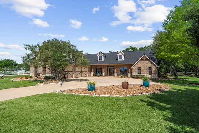 new england style home with fence, a front lawn, concrete driveway, an attached garage, and brick siding