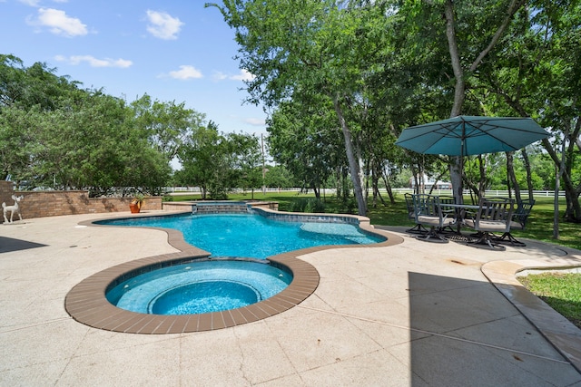 view of swimming pool with a patio area and a pool with connected hot tub