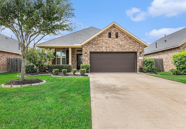 view of front of property with fence, an attached garage, a front lawn, brick siding, and concrete driveway