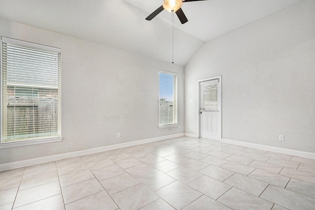 spare room with baseboards, ceiling fan, light tile patterned flooring, and vaulted ceiling