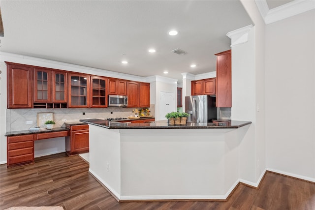 kitchen with backsplash, visible vents, crown molding, glass insert cabinets, and appliances with stainless steel finishes