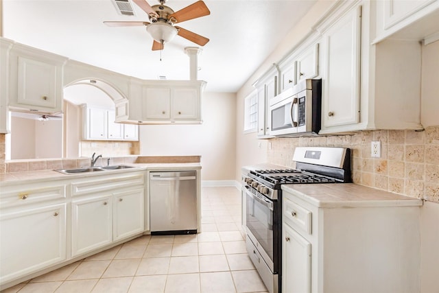 108 Harbour Town Cir, Conroe, TX 77356 - kitchen featuring tile countertops, stainless steel appliances, visible vents, and a sink