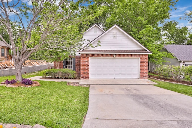 108 Harbour Town Cir, Conroe, TX 77356 - view of front facade featuring brick siding, an attached garage, a front lawn, and concrete driveway