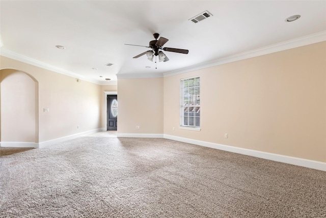 108 Harbour Town Cir, Conroe, TX 77356 - carpeted empty room with arched walkways, baseboards, visible vents, a ceiling fan, and ornamental molding