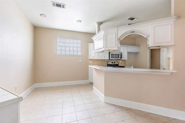 108 Harbour Town Cir, Conroe, TX 77356 - kitchen featuring stainless steel appliances, light countertops, visible vents, and white cabinetry