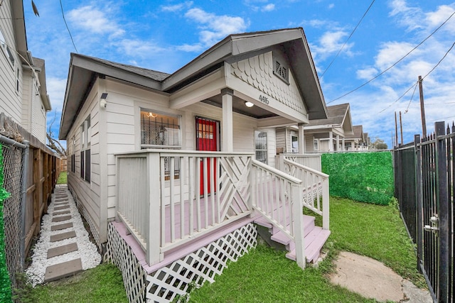 4415 Hershe St, Houston, TX 77020 - view of front of house featuring stairway, a fenced backyard, and a front lawn