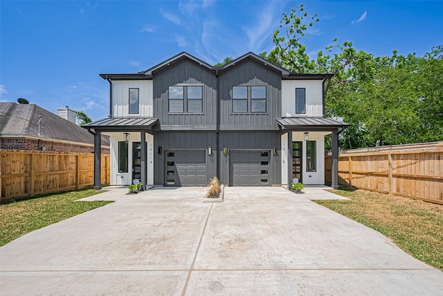 modern farmhouse style home with board and batten siding, a standing seam roof, concrete driveway, and metal roof